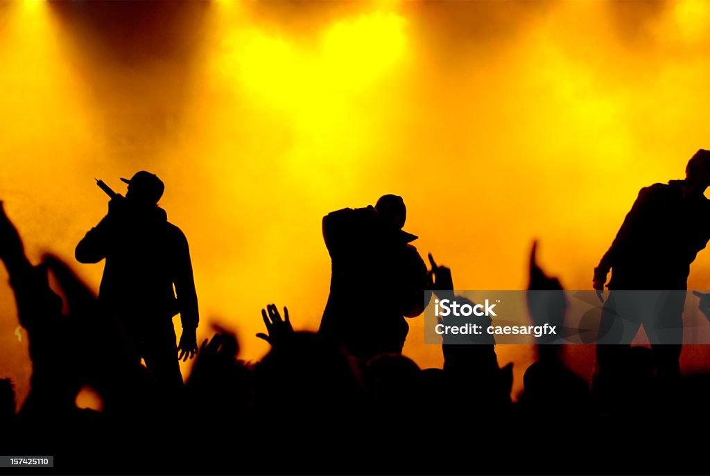 three rapper on stage. little noise and artefacts due to high iso